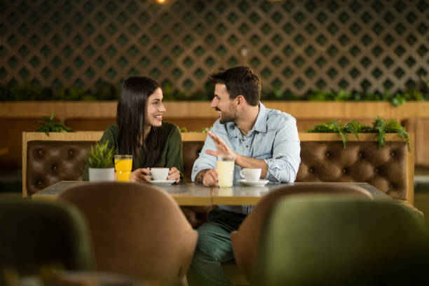 Happy friends communicating in a cozy cafe