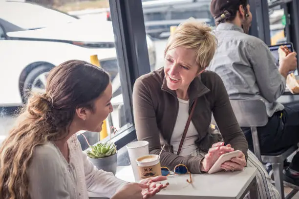 Parent and teen talking over coffee