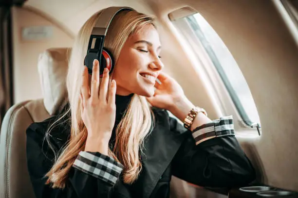 Traveler wearing ANC headphones on a long flight